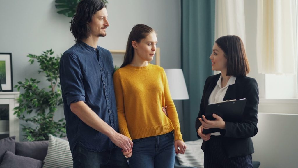 a group of people standing in a living room
